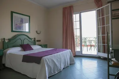 Cama o camas de una habitación en Hotel Mitra Crisálida