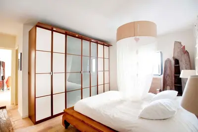 Cama o camas de una habitación en Un Oasis en el Corazón de Sevilla