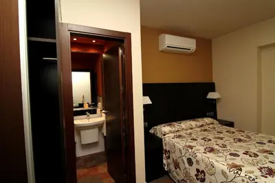 Cama o camas de una habitación en Hostal Restaurante La Bartola