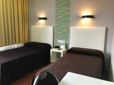 Cama o camas de una habitación en Hostal Restaurante EstaciÓN