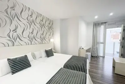 Cama o camas de una habitación en La Boutique Puerta Osario