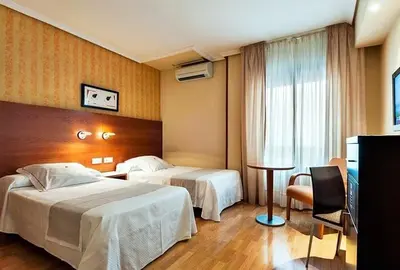 Cama o camas de una habitación en HOTEL XAUEN en pleno centro con acceso autorizado y a 100m de la Catedral