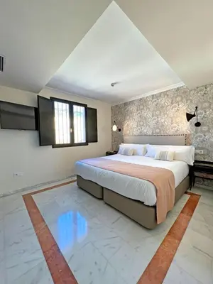 Cama o camas de una habitación en Itaca Sevilla by Soho Boutique