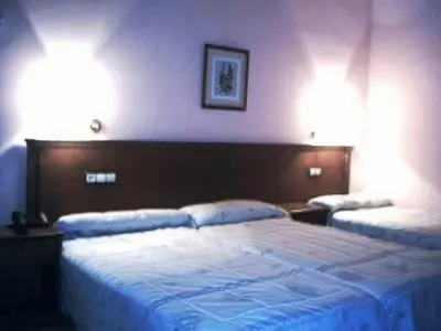 Cama o camas de una habitación en Hotel El Oasis