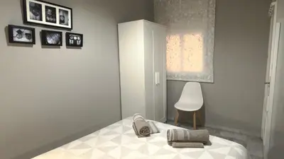 Cama o camas de una habitación en Casa San Martín Sevilla