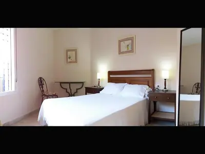 Cama o camas de una habitación en Apartamentos Sevilla
