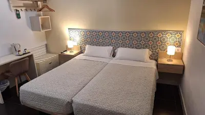Cama o camas de una habitación en Hostal San Vicente II