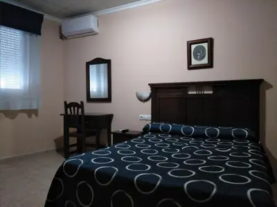 Cama o camas de una habitación en Hostal El Polígono