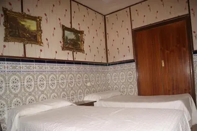 Cama o camas de una habitación en Hostal Alcázar