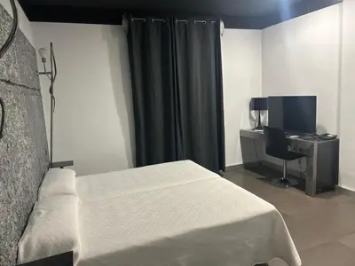 Una televisión o centro de entretenimiento en Hotel ACG