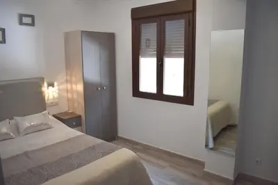 Cama o camas de una habitación en Iznájar Suites