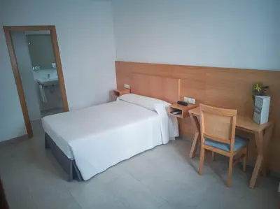 Cama o camas de una habitación en Hotel Abadi