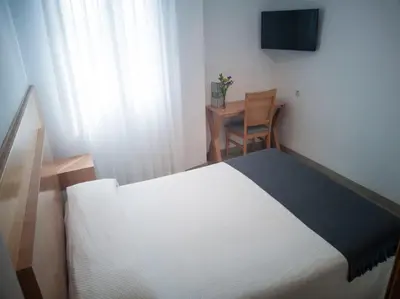 Cama o camas de una habitación en Hotel Abadi