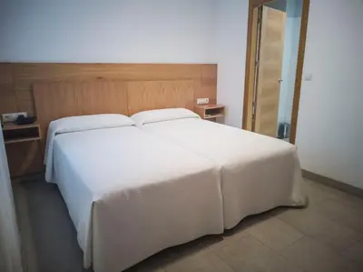 Cama o camas de una habitación en Hotel Abadi