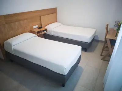 Cama o camas de una habitación en Hotel Abadi