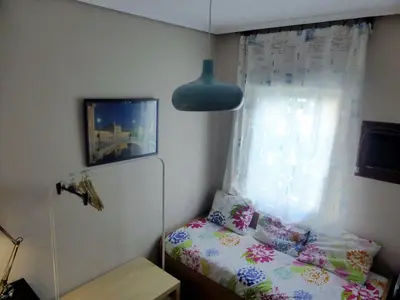 Cama o camas de una habitación en Esencia Sevilla