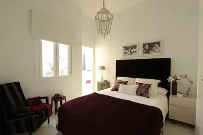 Cama o camas de una habitación en Apartamentos Plaza Pilatos