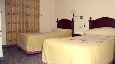 Cama o camas de una habitación en Hostal el Volao