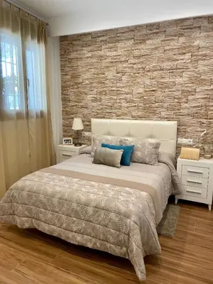 Cama o camas de una habitación en Apartamentos Cantarería, Jazmín.