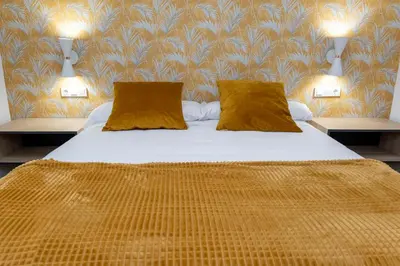 Cama o camas de una habitación en Apartamentos en Córdoba, Puente Romano y Torre Calahorra