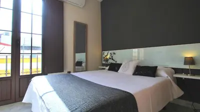 Cama o camas de una habitación en Living-Sevilla Apartments San Lorenzo