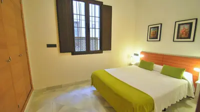 Cama o camas de una habitación en Living-Sevilla Apartments San Lorenzo