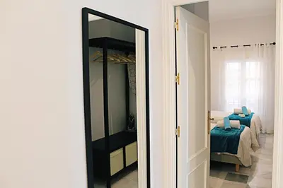 Cama o camas de una habitación en WISH SUITE SAN LUIS DE SEVILLA