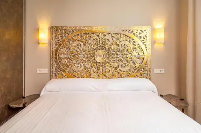 Cama o camas de una habitación en Apartamentos Sevilla Este by QHotels