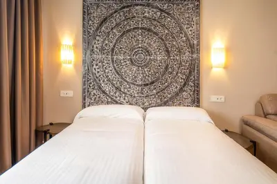 Cama o camas de una habitación en Apartamentos Sevilla Este by QHotels