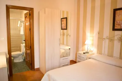 Cama o camas de una habitación en Pensión y apartamentos El Taxi