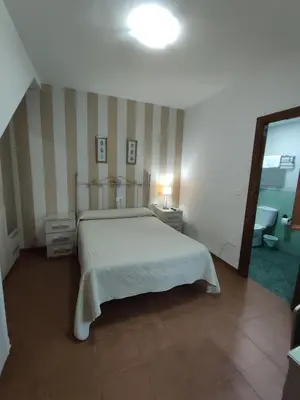 Cama o camas de una habitación en Pensión y apartamentos El Taxi