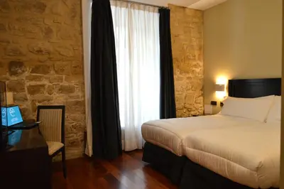 Cama o camas de una habitación en Hotel Baeza Monumental by eme hoteles