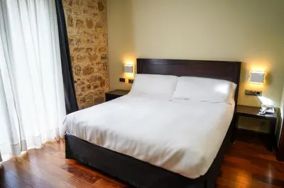 Cama o camas de una habitación en Hotel Baeza Monumental by eme hoteles