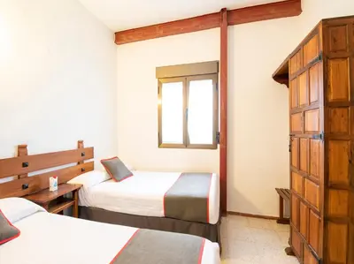 Cama o camas de una habitación en Hostal Santiago