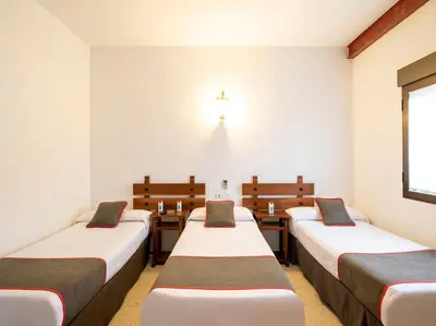 Cama o camas de una habitación en Hostal Santiago