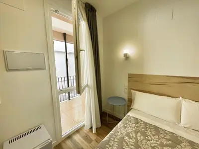 Cama o camas de una habitación en La Despensa de la Corredera Hostal
