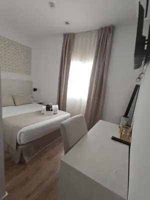 Cama o camas de una habitación en Le Petit Palü Sevilla