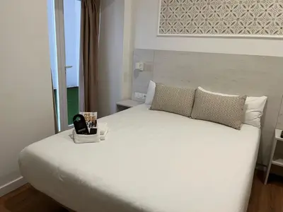Cama o camas de una habitación en Le Petit Palü Sevilla
