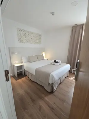Cama o camas de una habitación en Le Petit Palü Sevilla