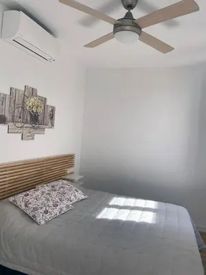Cama o camas de una habitación en Remolars Sevilla