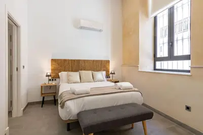 Cama o camas de una habitación en Nine O Clock San Agustin Suites