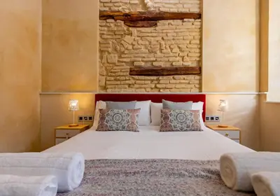Cama o camas de una habitación en Nine O Clock San Agustin Suites