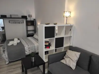 Cama o camas de una habitación en APARTAMENTO TURISTICO LYRA BAENA