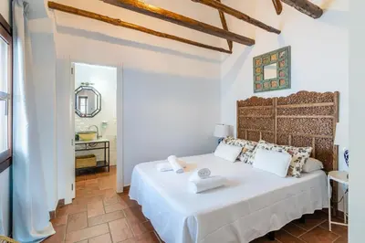 Cama o camas de una habitación en La Jⲟya de los Patios - Apartamentos Turísticos