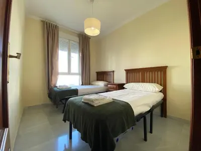 Cama o camas de una habitación en fantástico apartamento con parking avenida de cadiz