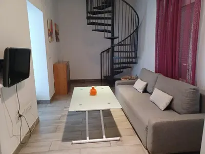 Una televisión o centro de entretenimiento en Apartamento en el casco antiguo en plena Alameda