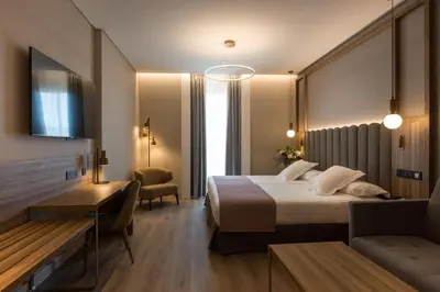 Cama o camas de una habitación en Hotel Giralda Center