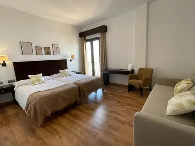 Cama o camas de una habitación en Hotel Cuatro Vientos