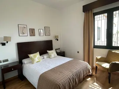 Cama o camas de una habitación en Hotel Cuatro Vientos