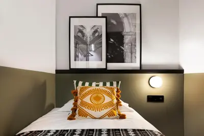 Cama o camas de una habitación en Doña Lola Alojamientos Boutique